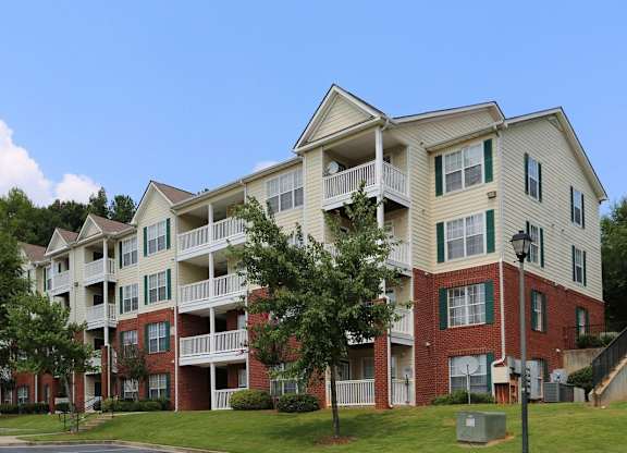 an exterior view of an apartment building on a sunny day