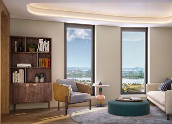 a living room with a couch and two chairs and some windows