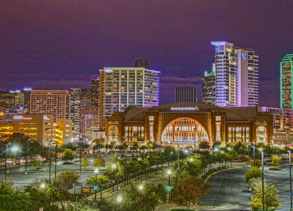 A cityscape at night with a large building in the center.