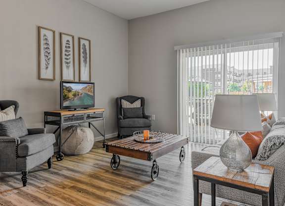 a living room with a couch and chairs and a table