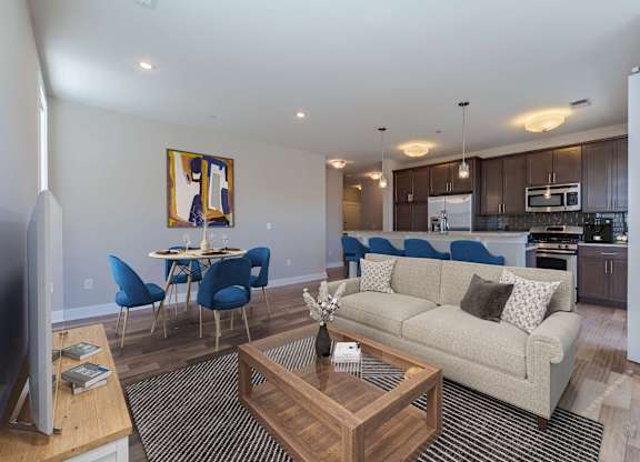 A living room with a couch, chairs, and a coffee table.