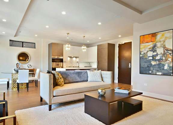A modern living room with a white couch and a coffee table.