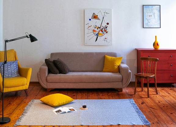 a living room with a couch and a chandelier