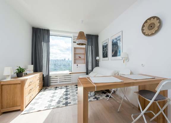 A room with a desk and a chair in it.