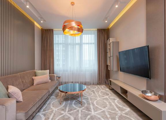 A modern living room with a sofa, coffee table, and television.
