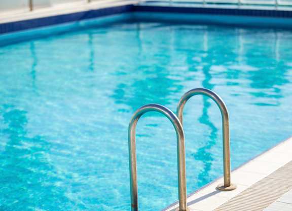 A pool with a metal ladder.