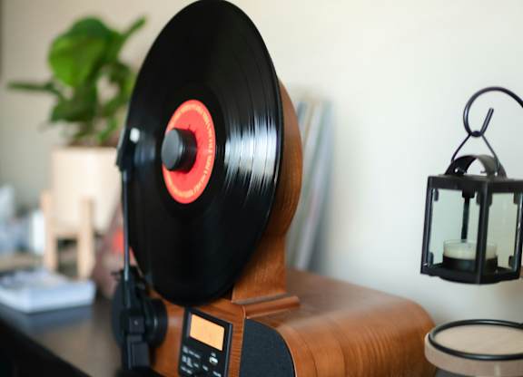 a vinyl record player sitting on top of a desk