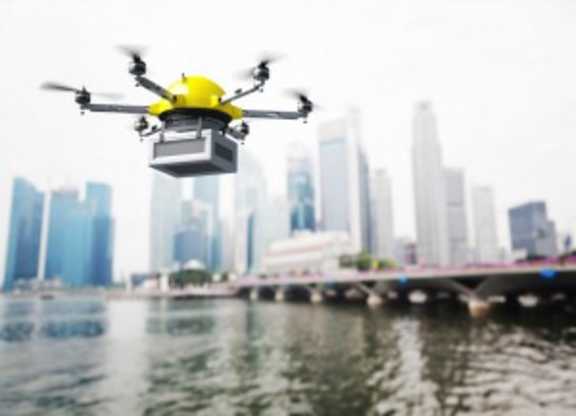 another asdf drone flying over the water with a city in the background