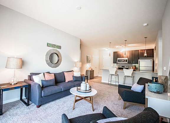 A living room with a grey couch and a coffee table.