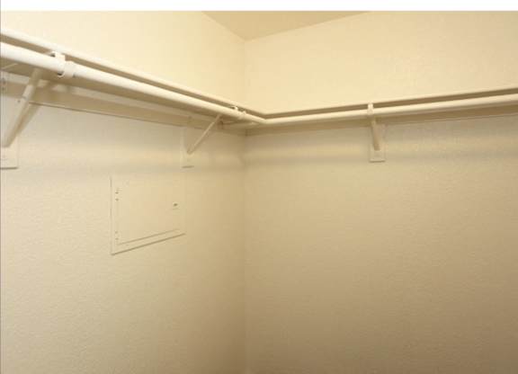 Closet with shelves at San Bellino Apartments, Glendale, AZ