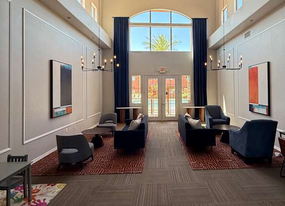 A large room with a carpeted floor and a long table with chairs on it.