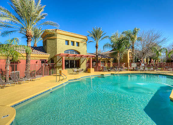 A pool surrounded by palm trees at San Miguel Apartments, Mesa, AZ 85212