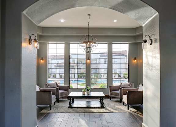 A large room with a pool table and chairs.