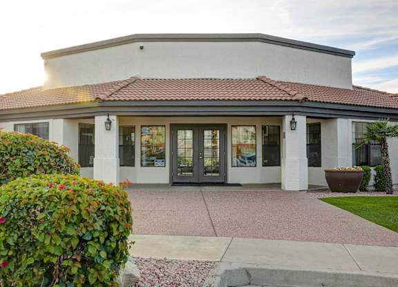 A building with a red tile roof and glass doors.