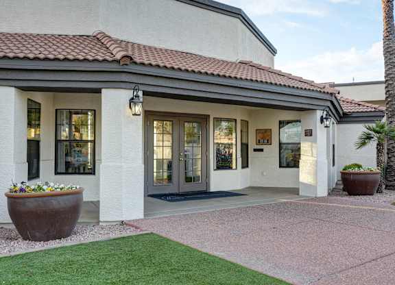 A building with a red tile roof and a glass door.