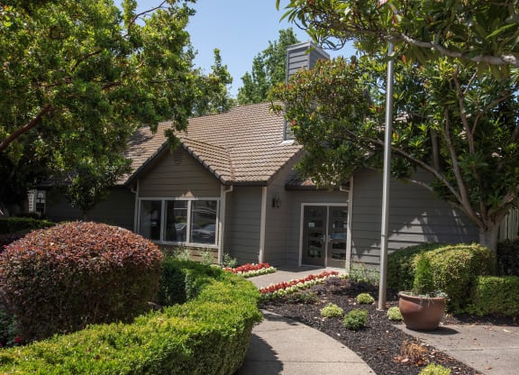 Bishops Court clubhouse exterior and path at Bishop's Court Apartments, Rancho Cordova, California 95670