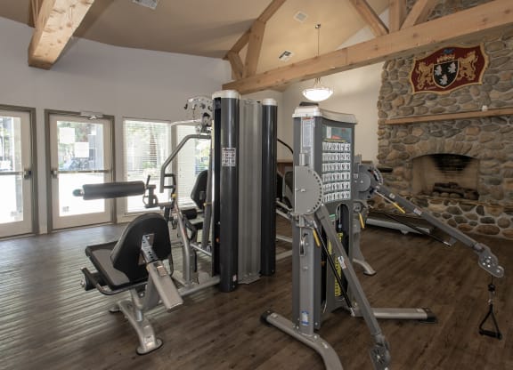Bishops Court fitness center machines and fireplace at Bishop's Court Apartments, Rancho Cordova, 95670