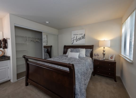 primary bedroom and vanity at Bishop's Court Apartments, Rancho Cordova, 95670