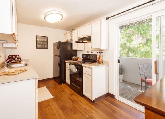 model kitchen and slider door to patio  at Clackamas Trails Apartments, OR 97222