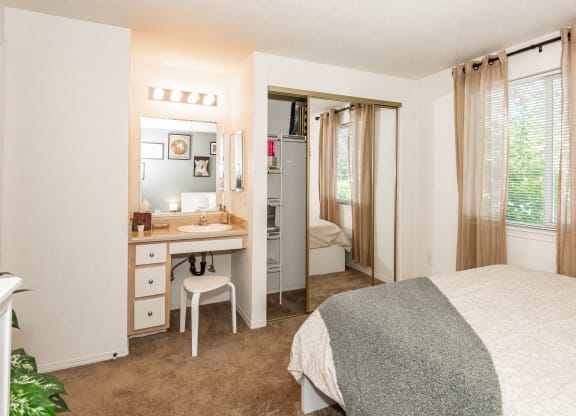 model primary bedroom and vanity  at Clackamas Trails Apartments, OR 97222