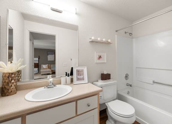 A white bathroom with a sink, toilet, and bathtub at Clackamas Trails Apartments, Oregon, 97222