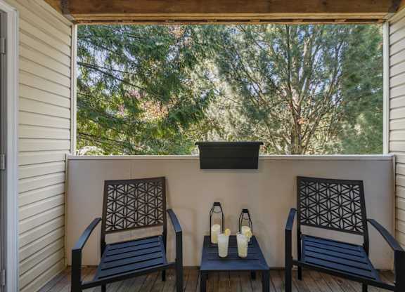 Two chairs and a table on a deck at Clackamas Trails Apartments, Oregon, 97222