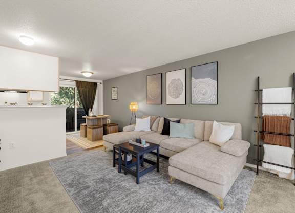 A living room with a grey rug and a white couch at Clackamas Trails Apartments, Oregon, 97222