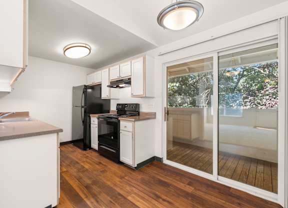 A kitchen with a refrigerator, oven, and sink at Clackamas Trails Apartments, Oregon, 97222