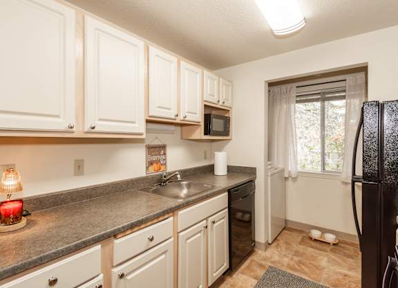 Model kitchen and laundry at King's Court Apartments, Beaverton, OR