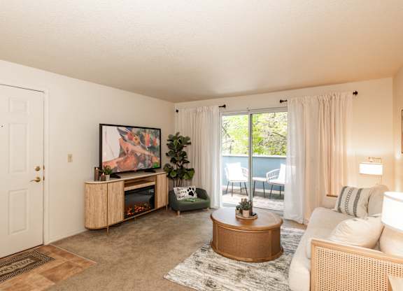Model living room and patio at King's Court Apartments, Beaverton, 97006