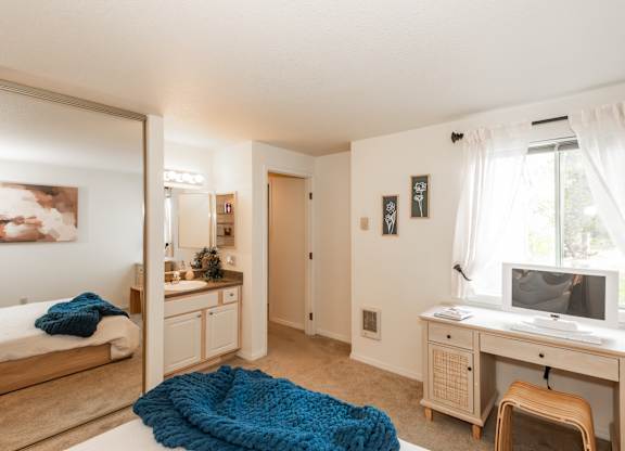 Model primary bedroom and vanity at King's Court Apartments, Beaverton, 97006