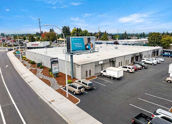 Park 219 South property entrance, parking lot, and store fronts