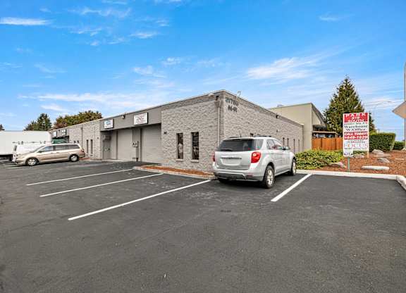 Park 219 South Exterior Building , Parking Lot, and Store Fronts