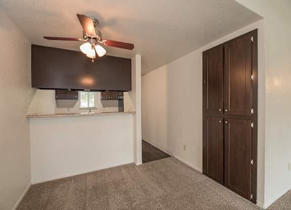 A room with a ceiling fan and a window with blinds at Pepperwood Apartments, California, 95661