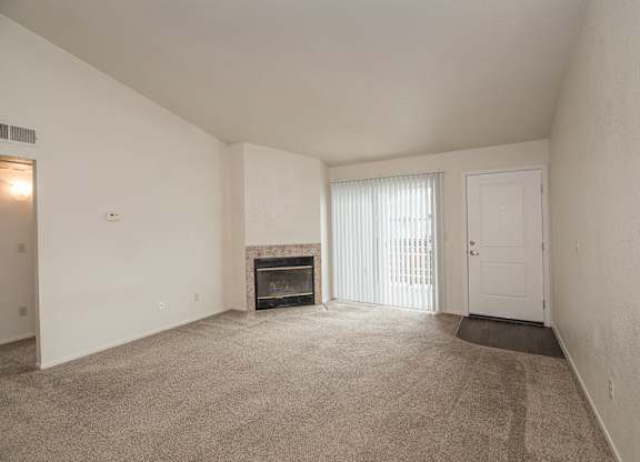 A room with a fireplace and a door at Pepperwood Apartments, California, 95661