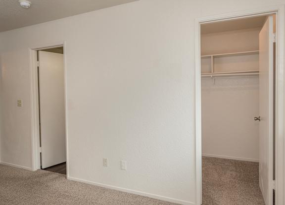 A white room with two open doors at Pepperwood Apartments, California, 95661