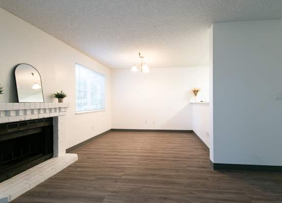 Vacant upgraded living room and fireplace at Riverwood Apartments, Kent, Washington 98032