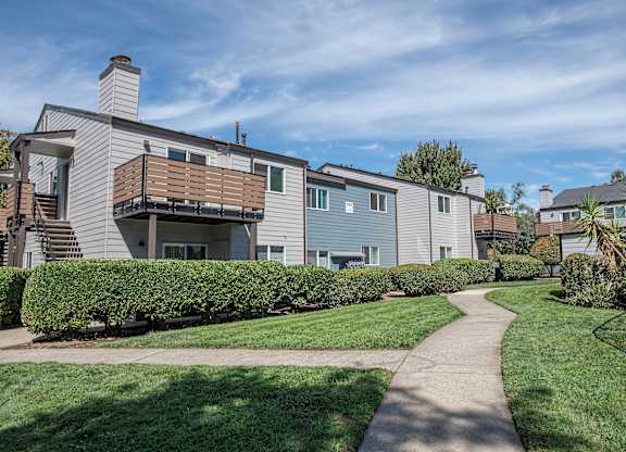 A green space and pathways in front of apartment buildings at Sierra Glen Apartments, California, 95621