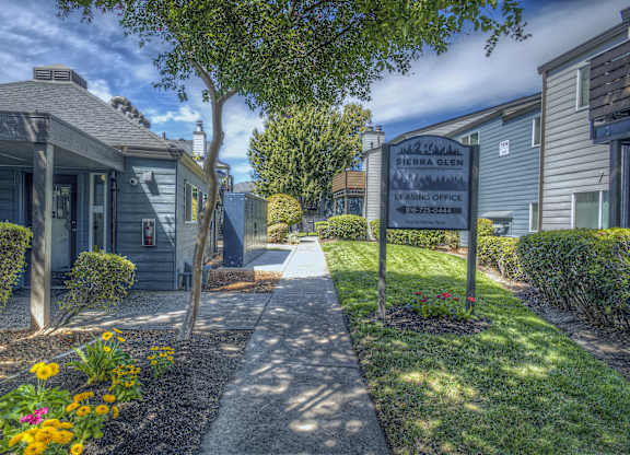 A sign for Sierra Glen Leasing Center stands in front of a building at Sierra Glen Apartments, California, 95621