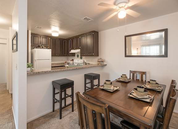A kitchen with a table set for four at Sierra Glen Apartments, California, 95621