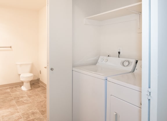 Stillwater vacant bathroom side view and full size washer and dryer in home laundry