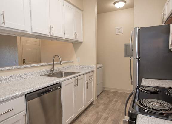 A kitchen with a stove, sink, and cabinets at Sunset Summit, Rocklin, CA, 95765