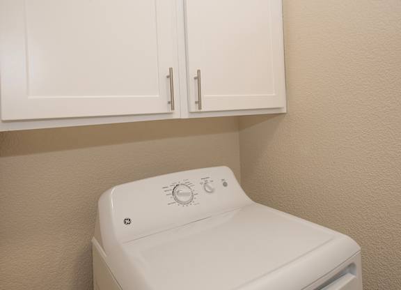 A white washing machine in a laundry room at Sunset Summit, Rocklin, CA, 95765
