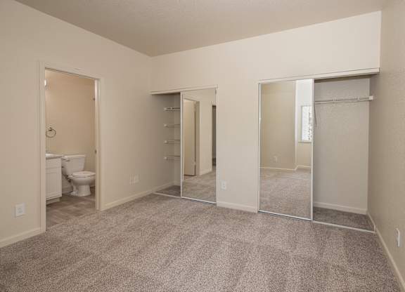 A room with a carpeted floor and mirrored closet doors at Sunset Summit, Rocklin, CA, 95765