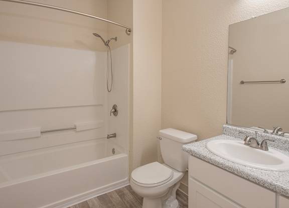 A white bathroom with a toilet, sink, and bathtub at Sunset Summit, Rocklin, CA, 95765