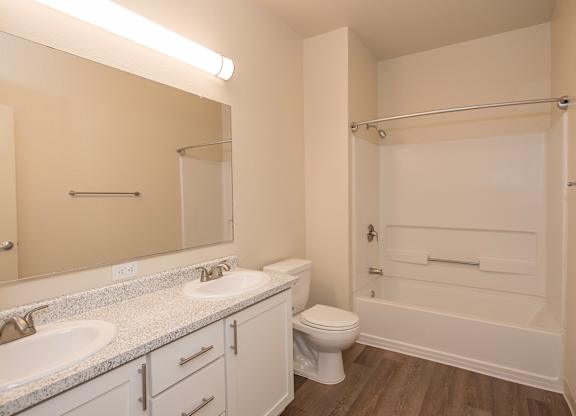 A white bathroom with a toilet, sink, and bathtub at Sunset Summit, Rocklin, CA, 95765