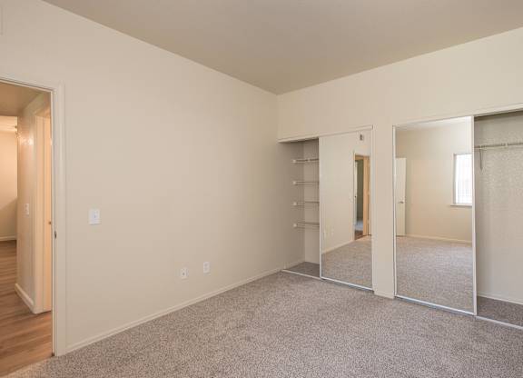 A large empty room with a carpeted floor and white walls at Sunset Summit, Rocklin, CA, 95765