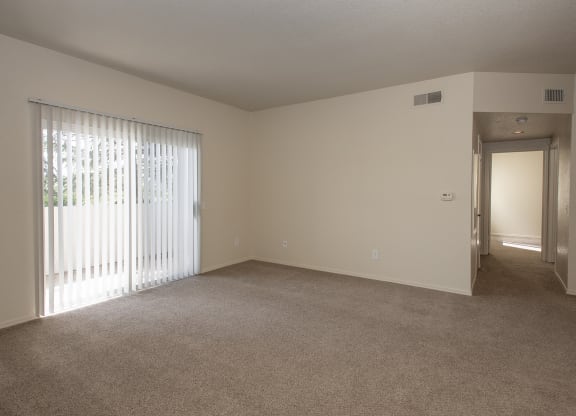Vacant living room and patio sliding door at Sunset Summit, Rocklin, CA 95765