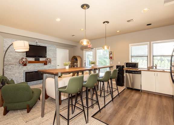 A modern kitchen with a dining table and chairs at Sunstone Parc, Beaverton, OR, 97008