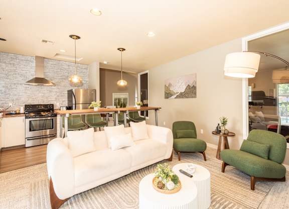 A modern living room with a white couch and green armchairs at Sunstone Parc, Beaverton, OR, 97008